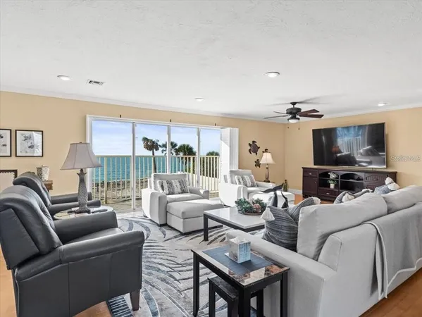 a living room with furniture ceiling fan and a rug