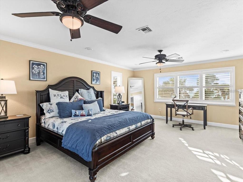 8030 Manasota Key Road Englewood, FL 34223 - Photo 18 of 67 a bedroom with a bed couch and a large window