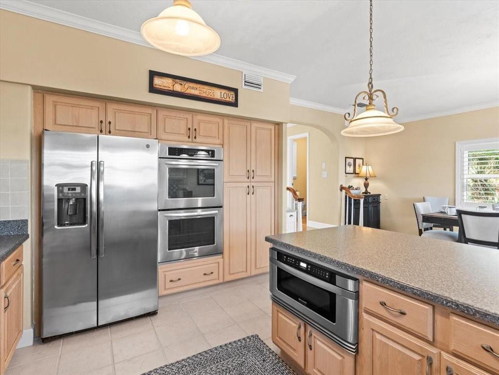 8030 Manasota Key Road Englewood, FL 34223 - Photo 19 of 67 a kitchen with stainless steel appliances a refrigerator a stove a sink and dishwasher