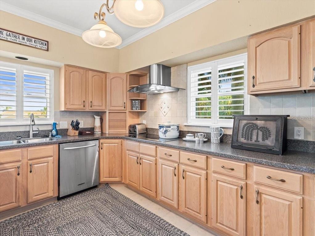 8030 Manasota Key Road Englewood, FL 34223 - Photo 20 of 67 a kitchen with granite countertop white cabinets and white stainless steel appliances