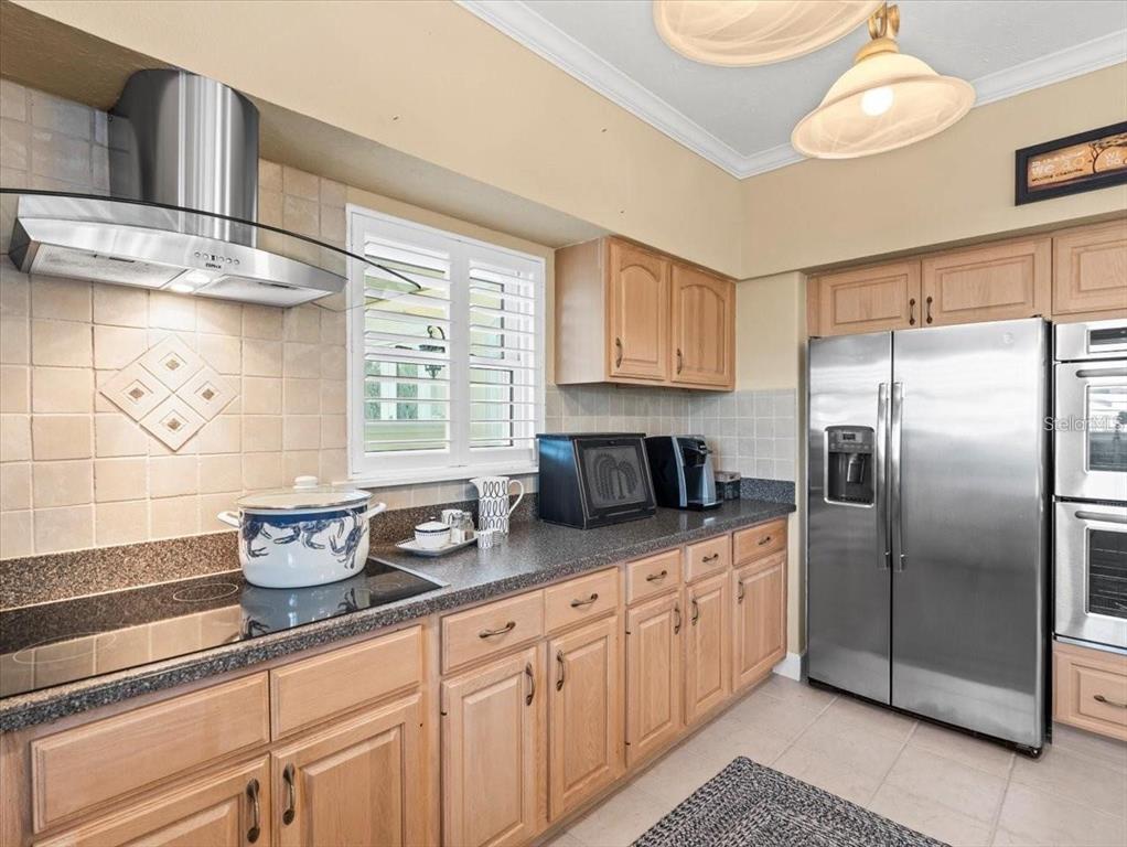 8030 Manasota Key Road Englewood, FL 34223 - Photo 21 of 67 a kitchen with stainless steel appliances granite countertop a refrigerator and a stove