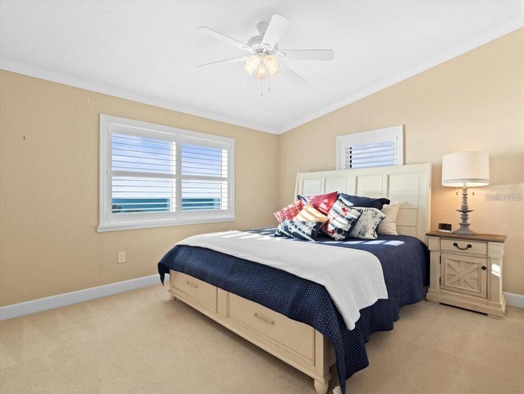 8030 Manasota Key Road Englewood, FL 34223 - Photo 30 of 67 a bedroom with a bed and a chandelier