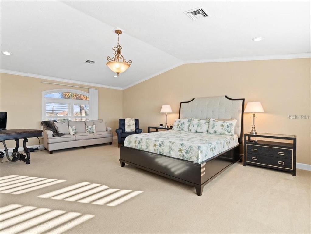 8030 Manasota Key Road Englewood, FL 34223 - Photo 33 of 67 a spacious bedroom with a bed and window