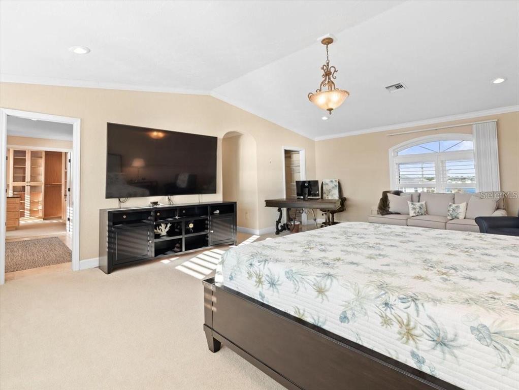 8030 Manasota Key Road Englewood, FL 34223 - Photo 34 of 67 a bedroom with a bed and a flat screen tv