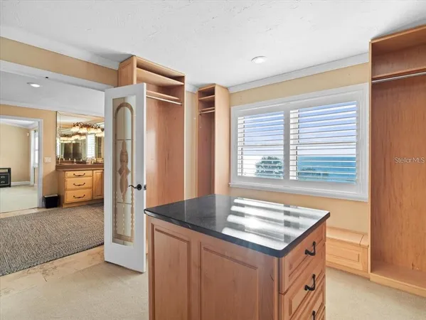 a kitchen with stainless steel appliances a table and chairs in it