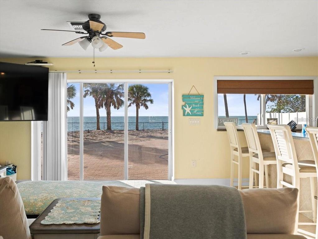 8030 Manasota Key Road Englewood, FL 34223 - Photo 47 of 67 a living room with furniture and a flat screen tv