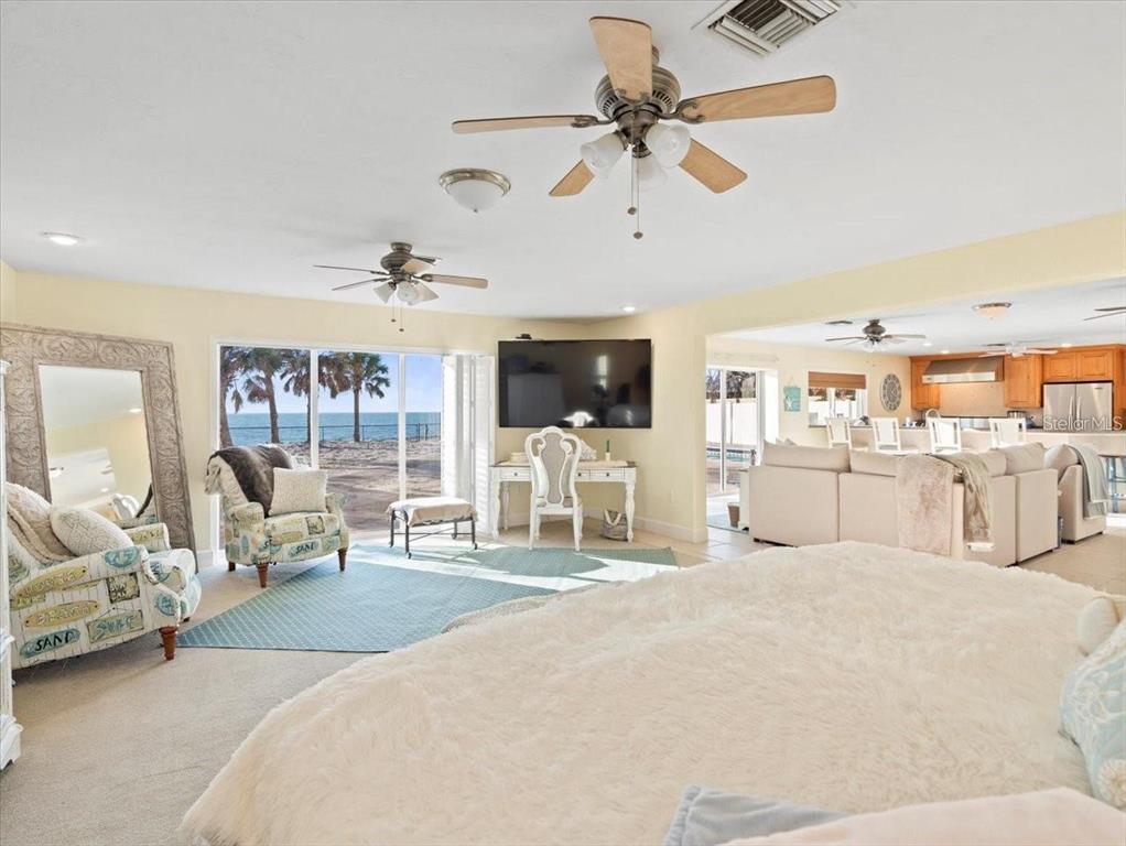8030 Manasota Key Road Englewood, FL 34223 - Photo 55 of 67 a large bedroom with a bed and a chandelier with kitchen view