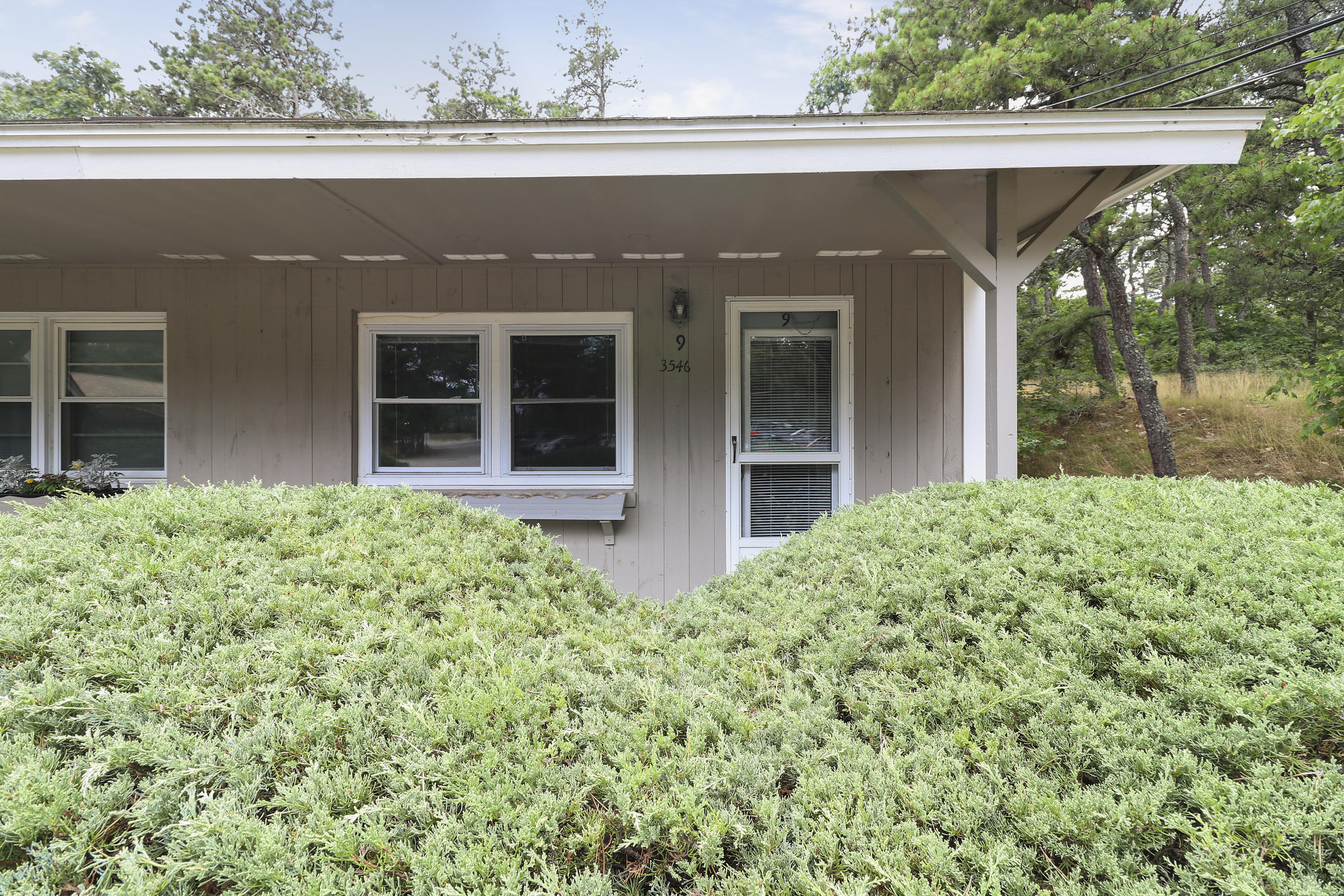 3546 Main Street, Unit 9 Brewster, MA 02631 - Photo 2 of 14 front view of a house with a yard