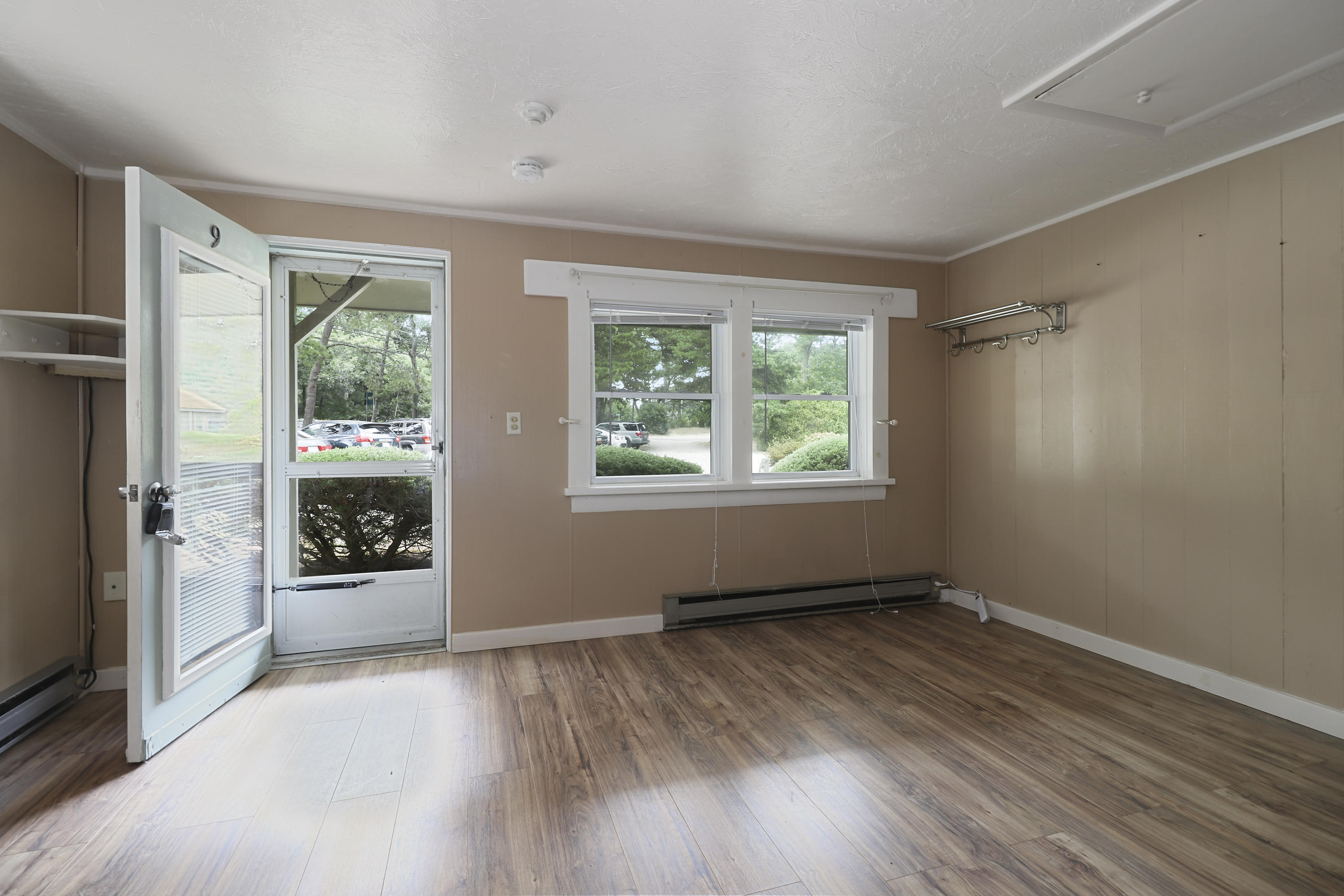 3546 Main Street, Unit 9 Brewster, MA 02631 - Photo 3 of 14 wooden floor in an empty room with a window