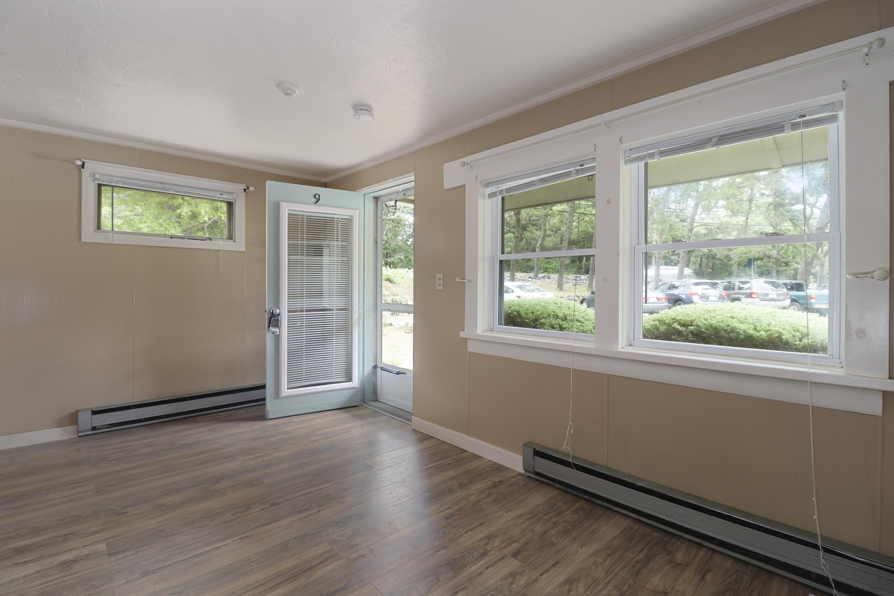 3546 Main Street, Unit 9 Brewster, MA 02631 - Photo 5 of 14 a view of an empty room with wooden floor and a window