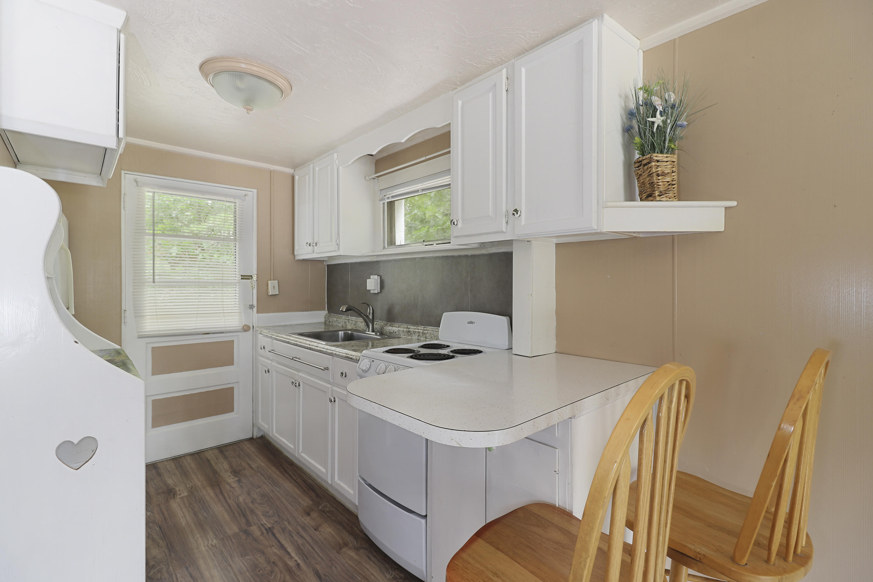3546 Main Street, Unit 9 Brewster, MA 02631 - Photo 6 of 14 a kitchen with a stove a sink and a refrigerator