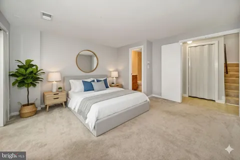 a bedroom with a bed and a potted plant