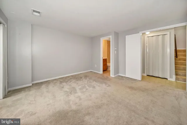 a view of an empty room and closet area