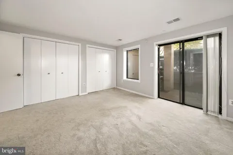 a view of an empty room with glass door