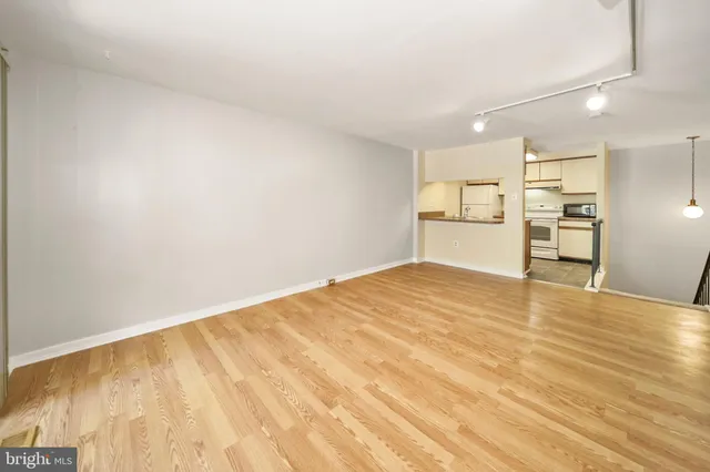 a view of empty room with wooden floor