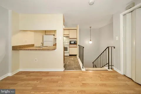 a view of a kitchen with a sink and cabinets