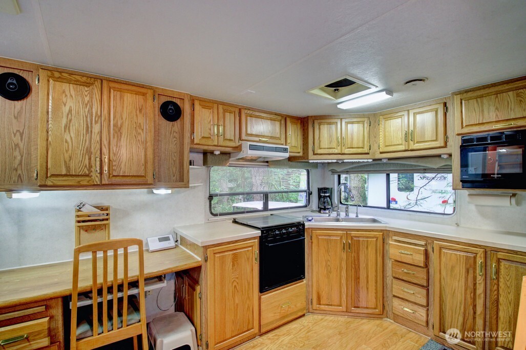 25-1 Goldrush Road Deming, WA 98244 - Photo 18 of 38 a kitchen with stainless steel appliances granite countertop a stove a sink and a microwave