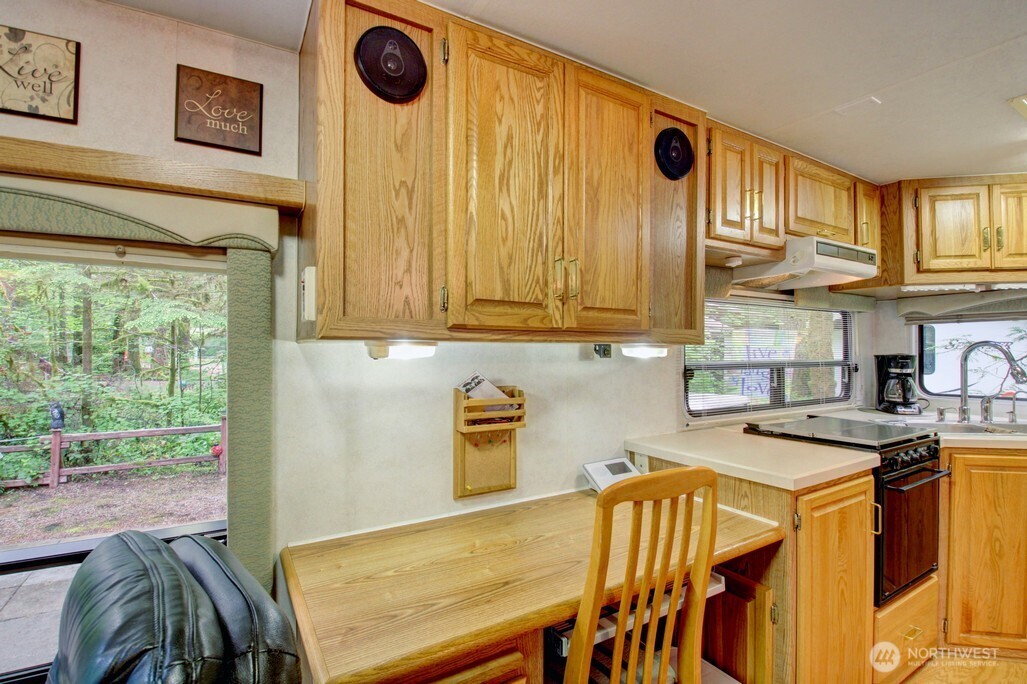 25-1 Goldrush Road Deming, WA 98244 - Photo 19 of 38 a kitchen with stainless steel appliances granite countertop a stove a sink and a microwave
