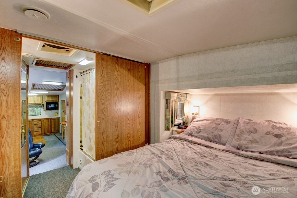 25-1 Goldrush Road Deming, WA 98244 - Photo 25 of 38 a bedroom with a bed and a large mirror