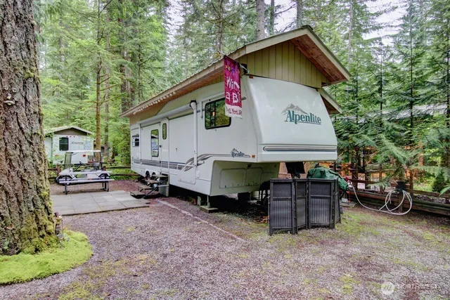 a view of a patio with table and chairs under an umbrella