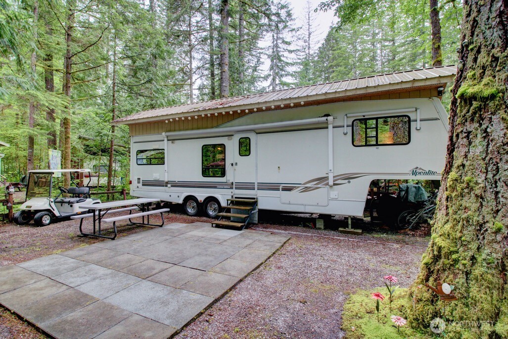 25-1 Goldrush Road Deming, WA 98244 - Photo 5 of 38 a backyard of a house with barbeque oven and outdoor seating