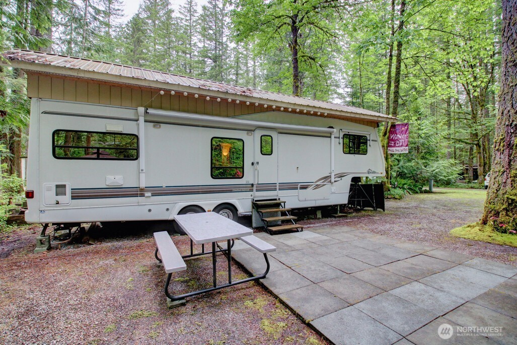 25-1 Goldrush Road Deming, WA 98244 - Photo 7 of 38 a backyard of a house with barbeque oven and outdoor seating