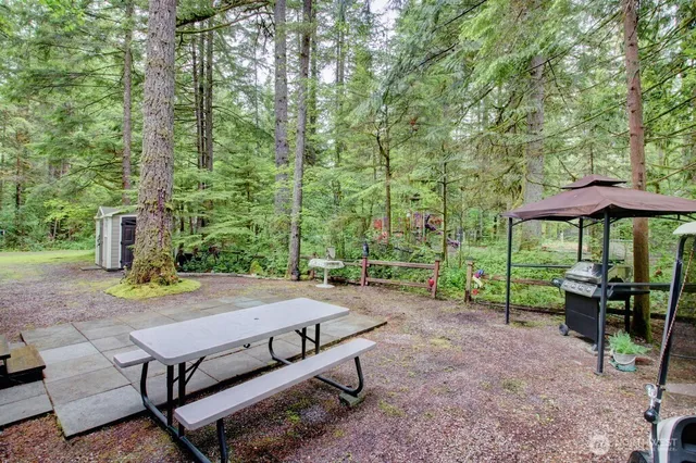 a view of a backyard with sitting area