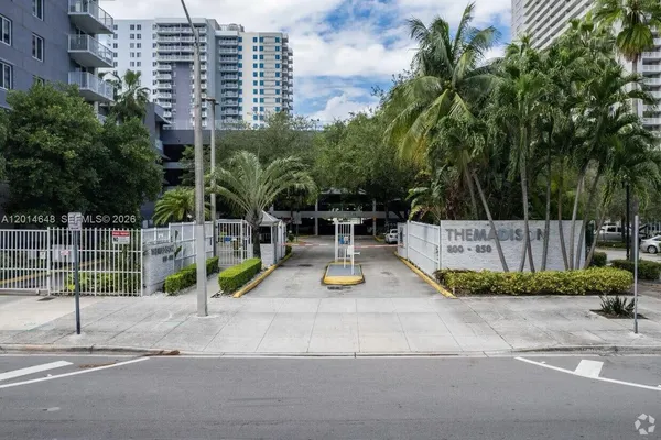 a view of a park with iron fence
