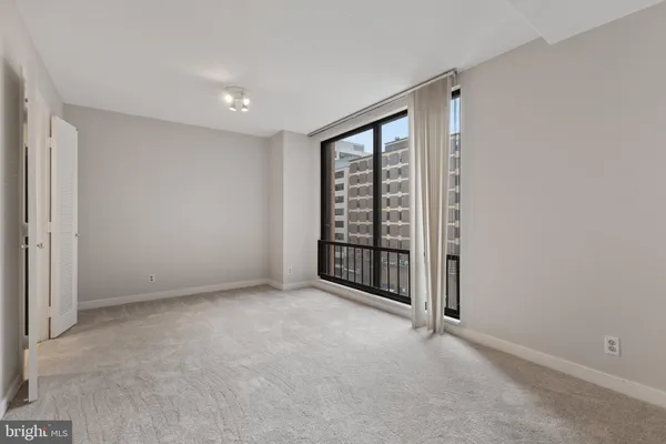 a view of an empty room with a window