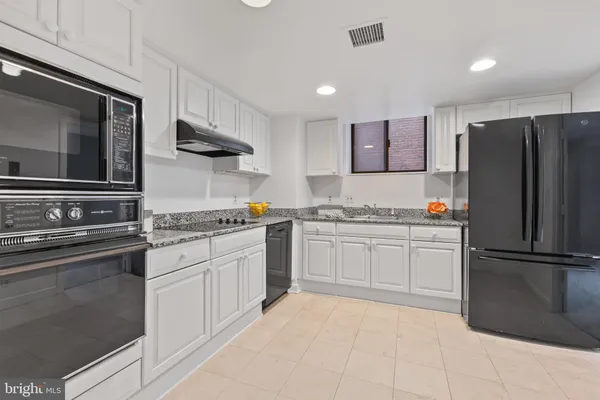 a kitchen with a refrigerator stove and sink