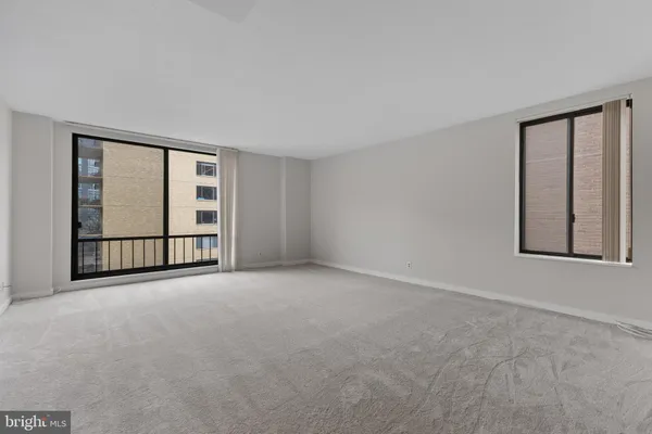 a view of an empty room with windows