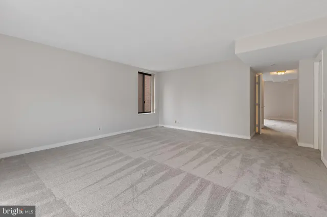 a view of an empty room with a window