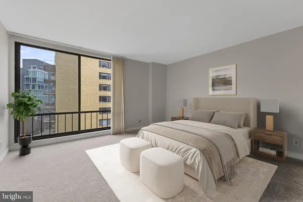 a spacious bedroom with a bed and a large window