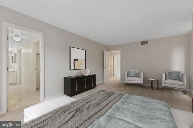 a spacious bedroom with a bed and a window