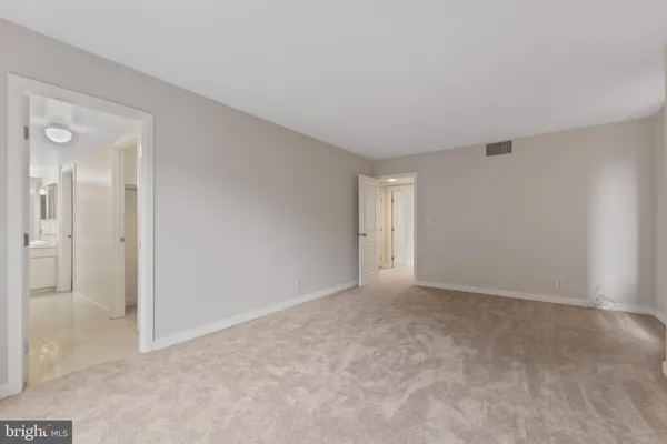 a view of an empty room and closet area