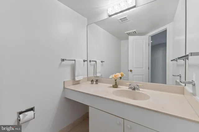 a view of a kitchen with refrigerator and a sink