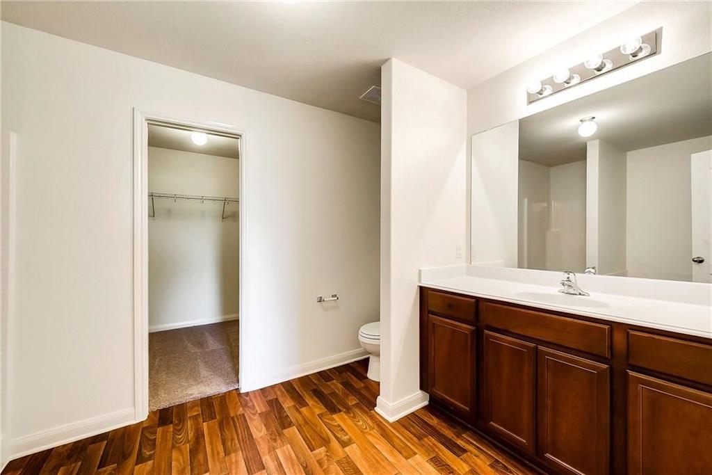 1810 Clegg Street Howe, TX 75459 - Photo 12 of 14 a spacious bathroom with a double vanity sink a mirror and a toilet