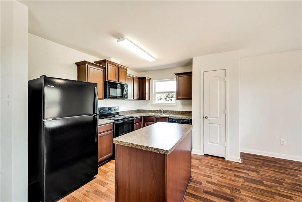 1810 Clegg Street Howe, TX 75459 - Photo 5 of 14 a kitchen with stainless steel appliances granite countertop a refrigerator a stove a sink and a microwave oven