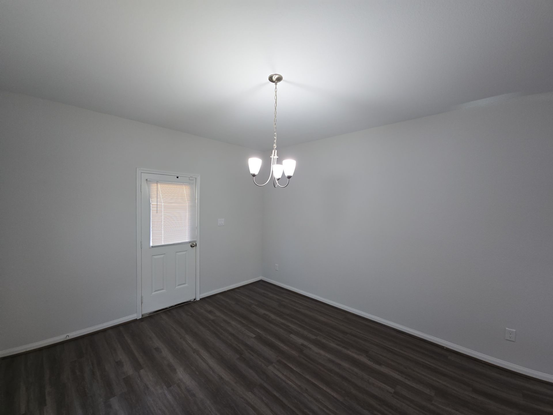9509 Madera Road, Unit A Houston, TX 77078 - Photo 16 of 29 a view of a room with wooden floor chandelier and a window