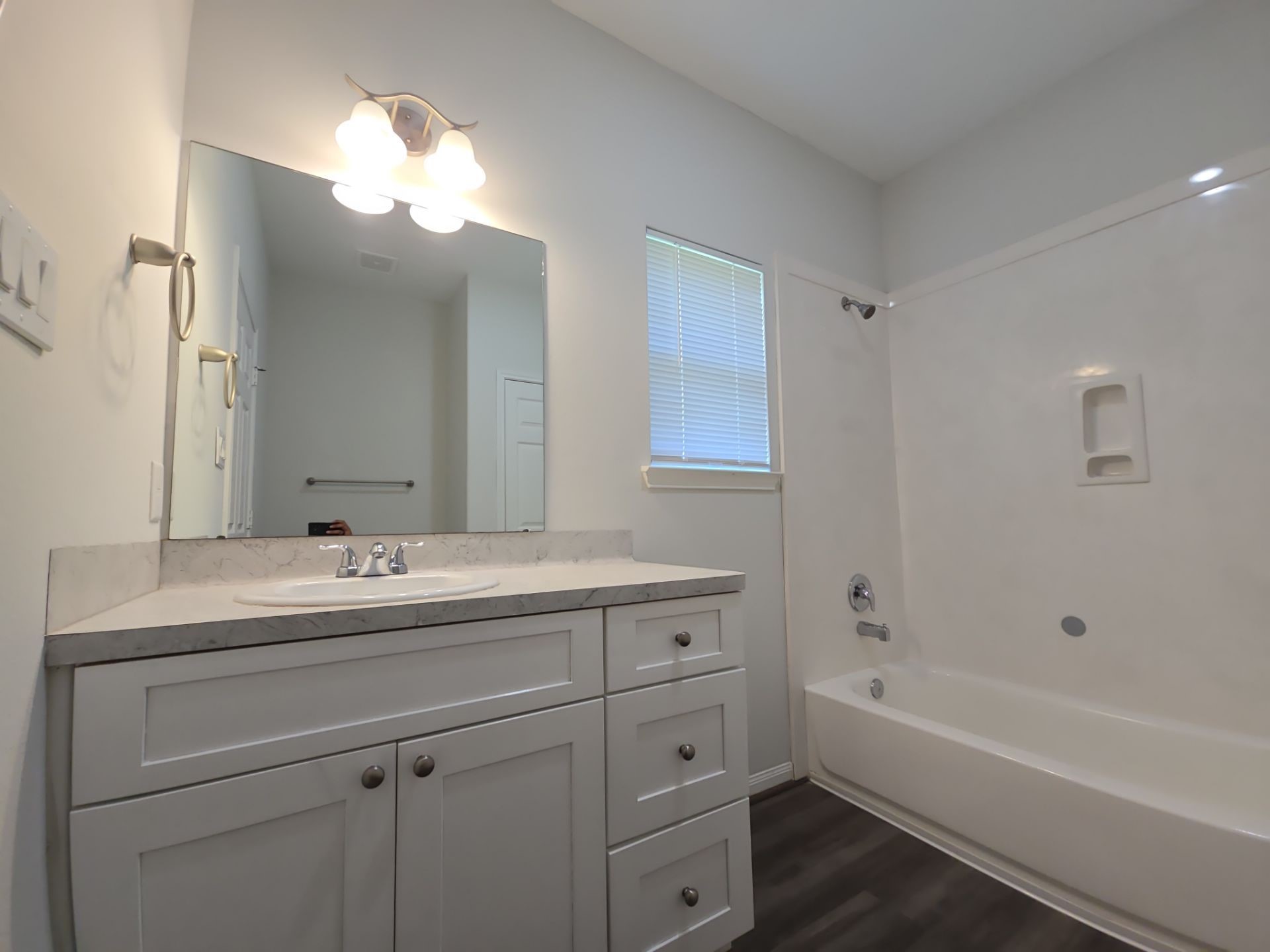 9509 Madera Road, Unit A Houston, TX 77078 - Photo 21 of 29 a bathroom with a sink a large mirror and a bathtub