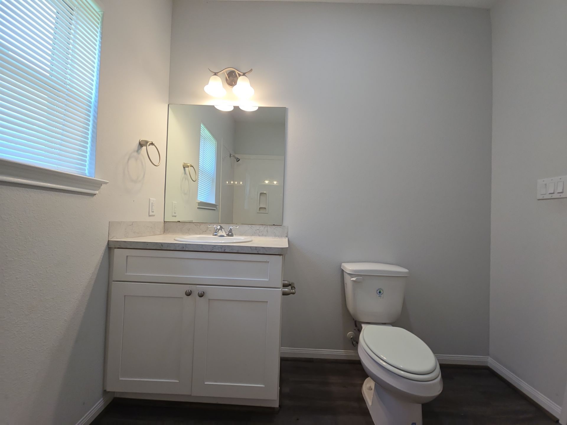 9509 Madera Road, Unit A Houston, TX 77078 - Photo 22 of 29 a bathroom with a toilet a sink and mirror