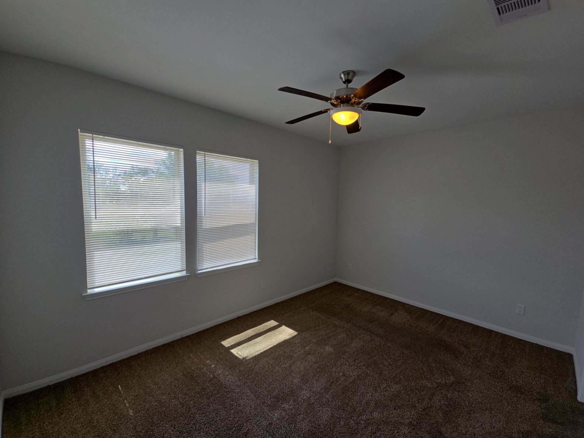 9509 Madera Road, Unit A Houston, TX 77078 - Photo 8 of 29 an empty room with a window and ceiling fan