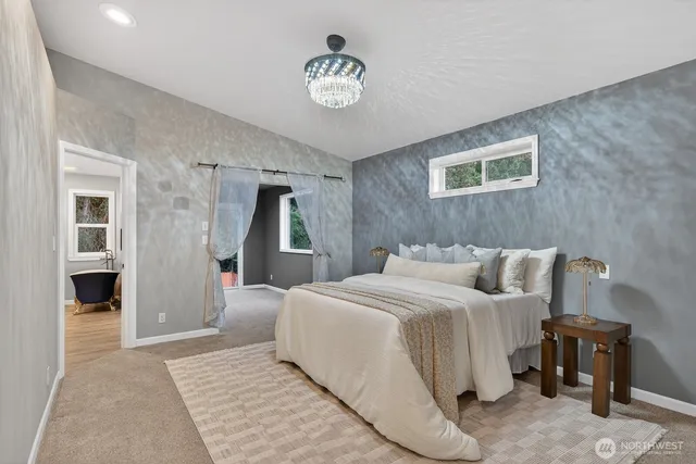 a bathroom with a tub a sink shower and mirror