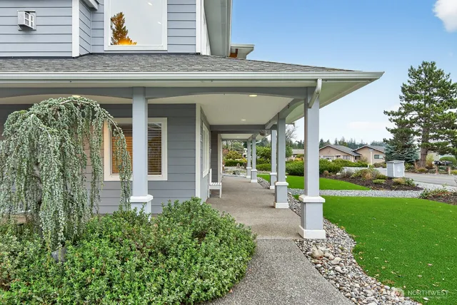a view of a house with fountain and a lawn chairs