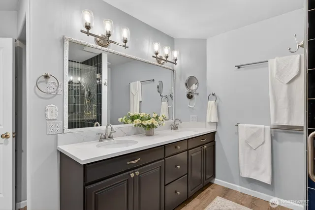 a bathroom with a granite countertop sink a toilet and a mirror