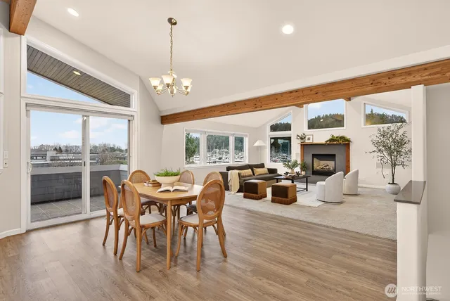 a living room with furniture fireplace and a large window