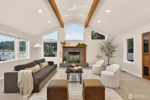 a view of swimming pool with lawn chairs and plants