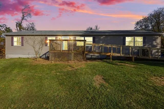a view of a house with a backyard