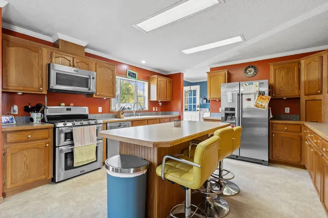 a kitchen with a stove a sink and a refrigerator