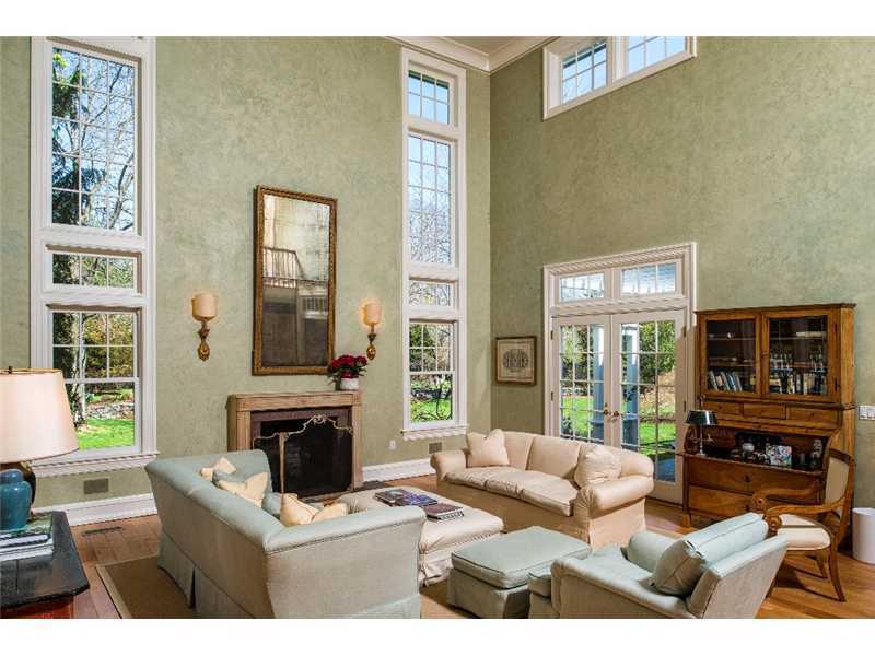 1021 Ponus Ridge Road New Canaan, CT 06840 - Photo 6 of 25 a living room with fireplace furniture and a large window